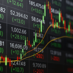 Imagem de tela com números de cotações, candles verdes e vermelhos e linha de tendência, representando a oscilação do mercado financeiro